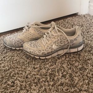 White and silver cheetah Nike tennis shoes